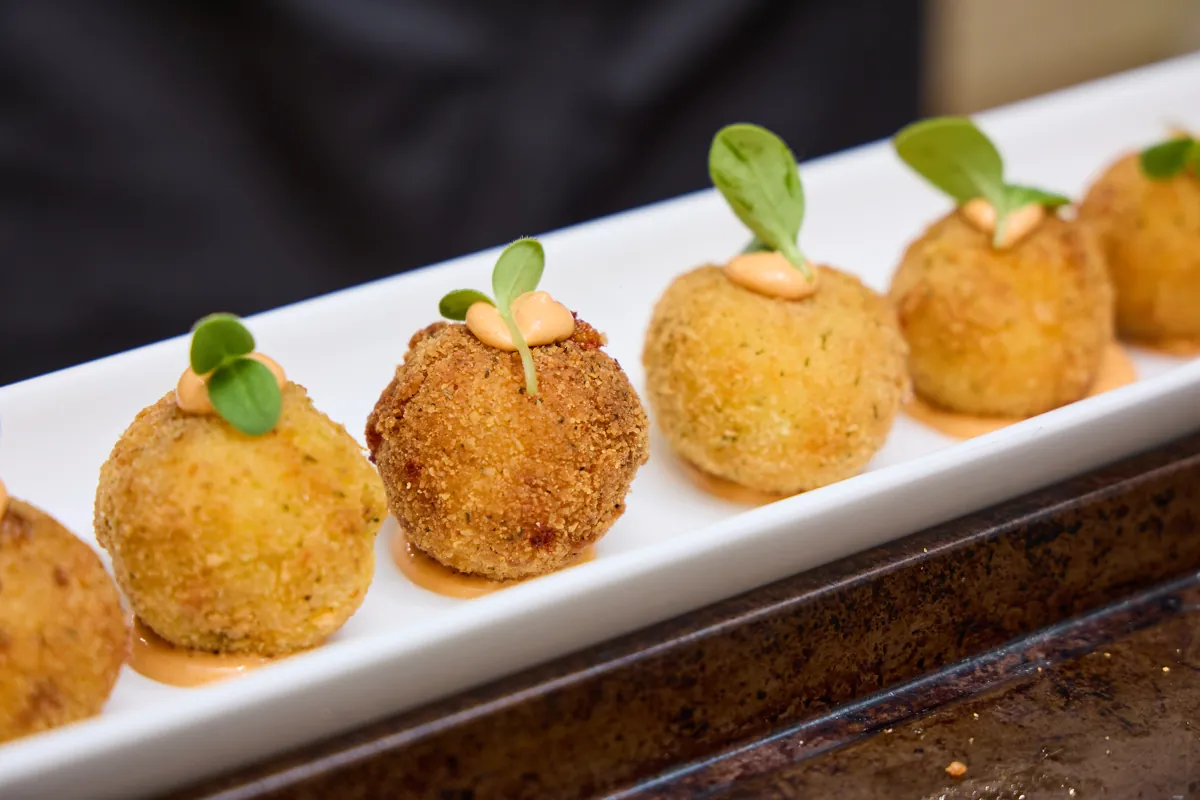 Passed rice-ball appetizers plated for catering