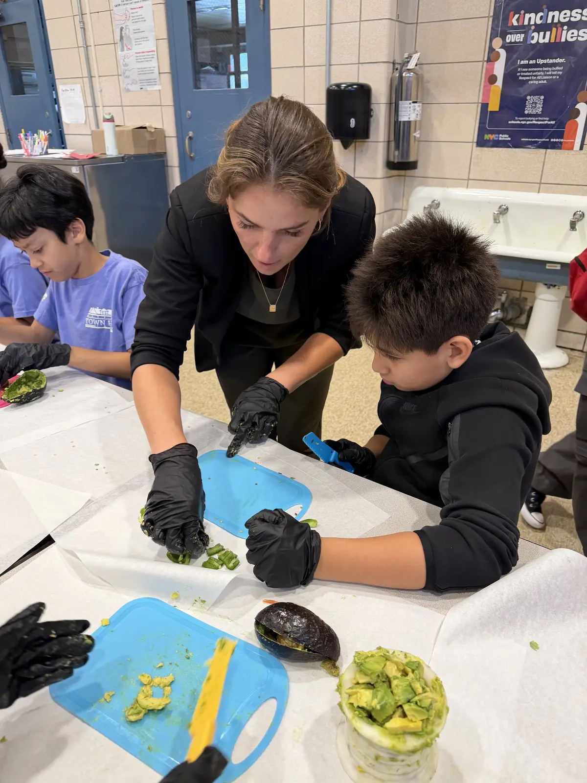 Students slicing fresh vegetables during an NTK cooking class